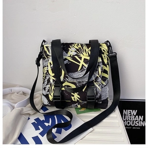 Detail of street graffiti oxford cloth bag with black buckles and yellow accents