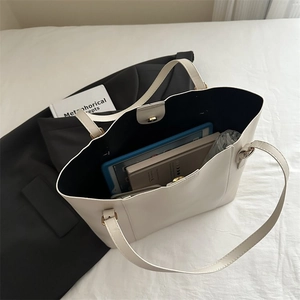 Internal view of cream tote bag showing large capacity for tablet, notebook and bottle