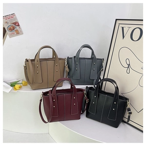 Litchi pattern tote bags in brown, grey, red, and black with golden rivet details