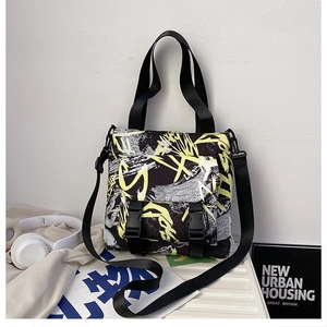 Detail of trendy graffiti oxford tote bag with dual buckles and adjustable strap