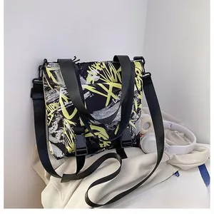 Detail of trendy graffiti oxford tote bag with durable plastic buckle and adjustable strap