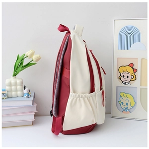 Side view of two-tone nylon backpack with elastic side pocket and breathable straps