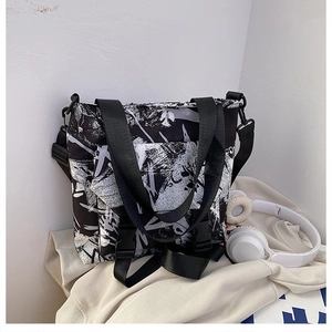 Detail of street style graffiti print oxford tote bag with adjustable shoulder strap and buckle