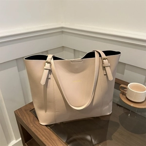 Chic beige tote bag on a wooden table in a cafe setting with an elegant vibe