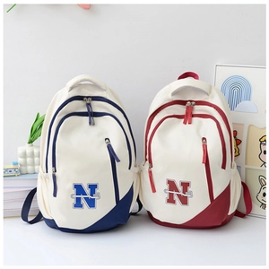 Detail showing high-density canvas material with embroidered N logo on the backpack