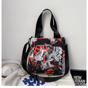 Detail of urban graffiti style oxford tote bag with buckle closure and adjustable strap