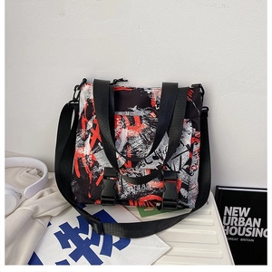 Detail of high-capacity oxford tote bag with graffiti print and functional buckles