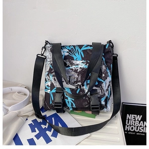 Detail view of Oxford cloth tote with graffiti print and dual buckle closures