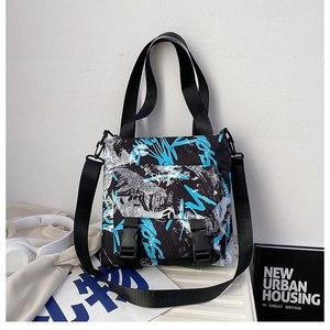 Detail of trendy color-block oxford tote with secure double buckle closure and straps