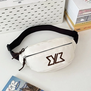 Detail of white canvas waist bag featuring brown 3D embroidered logo and woven zipper pull