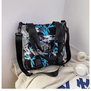 Detail view of street style graffiti oxford tote bag with buckle closure and wide strap