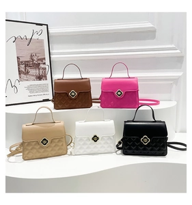 Detailed display of five colors of quilted PU leather handbags with clover turn-lock closure