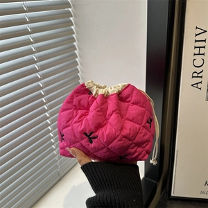 Quilted magenta bucket bag with drawstring and embroidery detail for autumn style