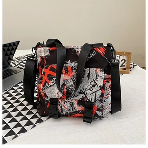 Close-up of graffiti print oxford messenger bag with adjustable strap and buckle closure