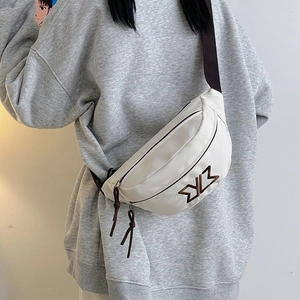 Detail of off-white canvas chest bag with brown embroidery logo and adjustable strap