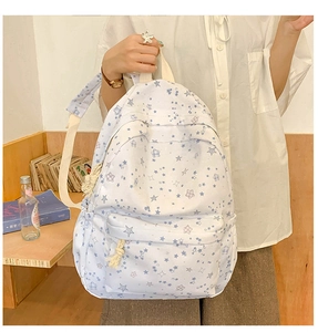 Close-up of star pattern canvas backpack with rope zippers and front pocket detail
