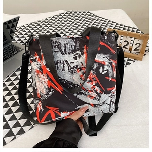 Close-up of urban graffiti printed oxford fabric bag with adjustable nylon straps