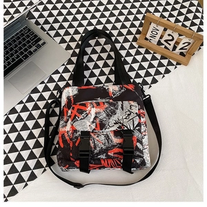 Detail of oxford cloth tote with red graffiti pattern and utilitarian buckle pockets