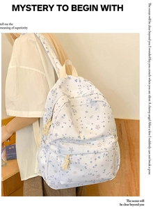 Side view of a fresh printed school backpack with star patterns and woven zipper pulls