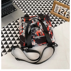 Detail view of the black and red graffiti Oxford tote bag with plastic buckles and handles