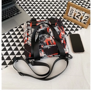 Detailed macro view of the graffiti print oxford tote bag with buckle and long nylon strap