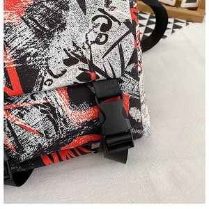 Close-up of graffiti-patterned oxford tote bag with durable black buckle and strap