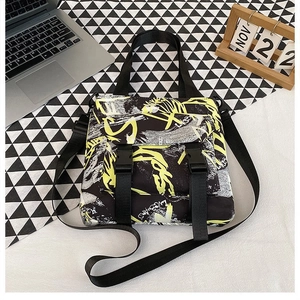 Detail of street style graffiti oxford bag with waterproof fabric and buckle closures