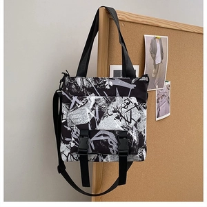 Detail of graffiti Oxford tote bag with dual plastic buckles and thick shoulder straps