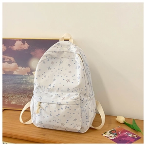 Detail of the high-capacity canvas backpack featuring blue star prints and side pockets