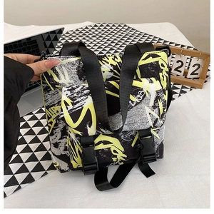Detail of graffiti-style oxford tote bag showing yellow prints and buckle closures
