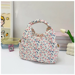 Detailed view of floral canvas lunch bag with pink roses and convenient side pockets