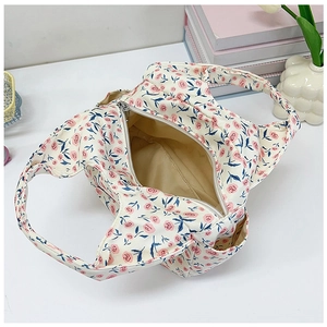 Internal view of the floral canvas handbag showing the metal zipper and spacious lining