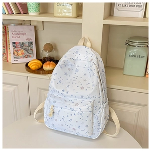 Close-up of star pattern student backpack with side pocket and cream shoulder strap