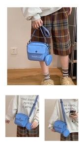 Detail of light blue nylon crossbody bag with mini coin purse and Dachshund embroidery