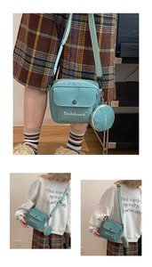 Detail view of mint green canvas crossbody bag featuring Dachshund embroidery and coin purse