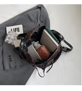 Top view showing large capacity interior of leopard print tote bag with daily essentials