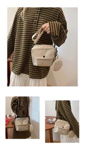 Detail of beige canvas crossbody bag featuring Dachshund embroidery and a small round coin purse