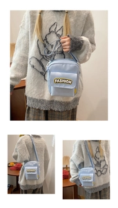 Detail of light blue nylon crossbody bag with fashion patch and adjustable strap