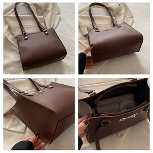Detail of dark brown tote bag showing multi-compartment interior and metal bow decoration
