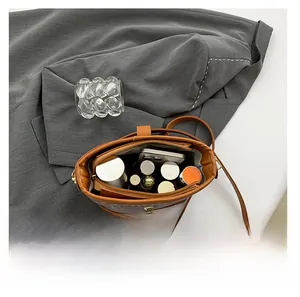Top view of brown leopard bucket bag interior showing phone and cosmetic storage space
