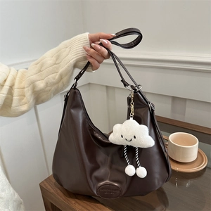 Dark brown matte leather hobo bag with a plush cloud charm and chain strap detail