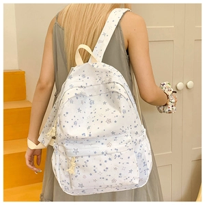Detailed back view of casual backpack with star patterns worn on a yellow staircase