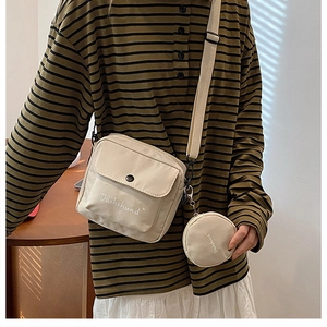 Detail of off-white canvas crossbody bag featuring a Dachshund print and round coin purse