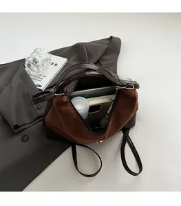 Detail view of large interior capacity showing a tablet and bottle in a brown tote bag