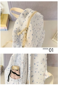 Detail showing the star-patterned backpack's dual zippers and functional side umbrella pocket