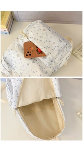 Detail view of floral star print backpack showing front pocket and interior compartment
