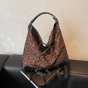 Fashionable leopard print canvas tote bag with black leather trim and bow decoration