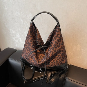 Chic leopard print hobo shoulder bag with black leather handles and bow detail
