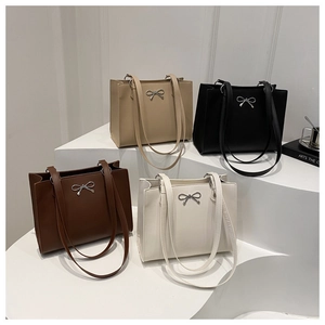Collection of minimalist faux leather tote bags in four colors with bow metal buckles