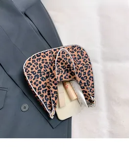 Top view of leopard print felt bag interior showing capacity for phone and cosmetics